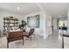Home office space with neutral walls, modern artwork, and decorative shelving at 3850 Royal Azalea Way, Sanford, FL 32773