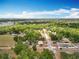 Wide aerial view of the property showing proximity to a lake and neighborhood at 398 Rose St, Umatilla, FL 32784