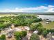 Scenic aerial view showcasing the property's proximity to lush greenery, water, and community at 398 Rose St, Umatilla, FL 32784