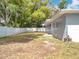 Wide backyard with trees, new fence, and plenty of space for activities at 398 Rose St, Umatilla, FL 32784