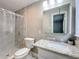 This bathroom has a tiled shower and granite countertop at 398 Rose St, Umatilla, FL 32784
