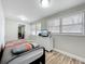 Bedroom features two windows with blinds, a bed, and a dresser with TV at 398 Rose St, Umatilla, FL 32784