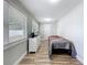 Bedroom featuring windows with blinds, a bed, and dresser at 398 Rose St, Umatilla, FL 32784
