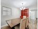 Elegant dining room with a large wood table, decorative chairs, and stylish hutch, perfect for entertaining at 398 Rose St, Umatilla, FL 32784