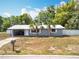 Charming single-story home featuring a light gray exterior and two palm trees in the front yard at 398 Rose St, Umatilla, FL 32784