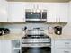 Stainless steel microwave and stove top oven in the kitchen at 398 Rose St, Umatilla, FL 32784
