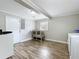 Bright laundry room features wood flooring, white walls, and modern appliances at 398 Rose St, Umatilla, FL 32784
