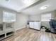 Spacious laundry room with wooden flooring, ample natural light, and laundry appliances at 398 Rose St, Umatilla, FL 32784