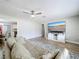 Cozy living room with a large sofa, modern television, and views into the dining area at 398 Rose St, Umatilla, FL 32784