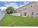 Well-maintained backyard featuring a lush lawn and white fencing at 5102 Monticello Heights Ln, Oviedo, FL 32765