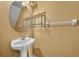 Simple half bathroom featuring a pedestal sink, mirror, and neutral wall color at 5102 Monticello Heights Ln, Oviedo, FL 32765
