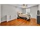 Bedroom features wood flooring, dresser and ceiling fan at 5102 Monticello Heights Ln, Oviedo, FL 32765