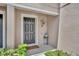 Inviting entryway featuring a dark front door, attractive decor, and a welcome mat at 5102 Monticello Heights Ln, Oviedo, FL 32765