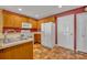 Well-equipped kitchen featuring wooden cabinets, modern appliances, and a functional layout at 5102 Monticello Heights Ln, Oviedo, FL 32765