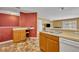 Open kitchen with warm-toned cabinets, modern appliances, and a convenient breakfast bar at 5102 Monticello Heights Ln, Oviedo, FL 32765