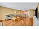 Open-concept living area with hardwood floors, comfortable seating, and a seamless transition to the kitchen at 5102 Monticello Heights Ln, Oviedo, FL 32765