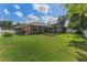 Large backyard with a screened lanai, lush green grass, and white fencing at 530 Heatheroak Cv, Altamonte Springs, FL 32714