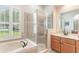 A bright bathroom with a soaking tub and glass enclosed shower at 530 Heatheroak Cv, Altamonte Springs, FL 32714