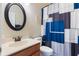 Bathroom with a modern geometric shower curtain, round mirror, and classic fixtures at 530 Heatheroak Cv, Altamonte Springs, FL 32714