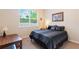 Bright bedroom with a large window letting in natural light and modern striped bedding at 530 Heatheroak Cv, Altamonte Springs, FL 32714