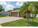 Attached two-car garage with mature palms and ample parking space on a sunny day at 530 Heatheroak Cv, Altamonte Springs, FL 32714
