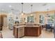 A kitchen with stainless steel appliances, wood cabinets and granite countertops open to the fireplace and dining room at 530 Heatheroak Cv, Altamonte Springs, FL 32714
