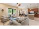 Bright and open living room with large windows, bar seating, and a view of the pool at 530 Heatheroak Cv, Altamonte Springs, FL 32714