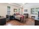 A main bedroom with wood floors, a ceiling fan, and lots of windows at 530 Heatheroak Cv, Altamonte Springs, FL 32714