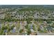 This aerial showcases the community's layout, featuring a mix of homes, pools, and greenery at 5583 Miles Dr, Port Orange, FL 32127