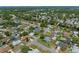 Shows an aerial view of a community featuring homes with pools and lush landscaping at 5583 Miles Dr, Port Orange, FL 32127
