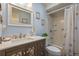 Well-lit bathroom with a vanity with framed mirror, tub and shower combo with butterfly curtain at 5583 Miles Dr, Port Orange, FL 32127