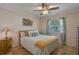 Bedroom features a bed, side table with lamp, and a large window with natural light at 5583 Miles Dr, Port Orange, FL 32127