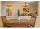 Dining area features a wood table with seating, decorative plant centerpiece, and chandelier lighting at 5583 Miles Dr, Port Orange, FL 32127