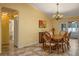 Dining room with table and four chairs plus decorative chandelier and view of living room at 5583 Miles Dr, Port Orange, FL 32127