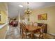 Dining room with table, six chairs, and view of living room and entry area at 5583 Miles Dr, Port Orange, FL 32127