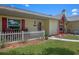 Inviting covered front porch with chairs and a charming white picket fence at 5583 Miles Dr, Port Orange, FL 32127