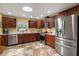 Kitchen with stainless steel appliances, cherry cabinets, and granite countertops at 5583 Miles Dr, Port Orange, FL 32127