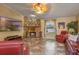 Cozy living room with a stone fireplace, tile floors and comfortable seating at 5583 Miles Dr, Port Orange, FL 32127