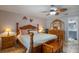 This main bedroom features a bed, dresser with mirror and attached bathroom at 5583 Miles Dr, Port Orange, FL 32127