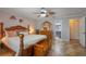 This main bedroom features a bed, dresser with mirror and attached bathroom at 5583 Miles Dr, Port Orange, FL 32127