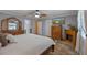 The main bedroom features a bed, fireplace, mounted tv and attached bathroom at 5583 Miles Dr, Port Orange, FL 32127
