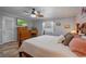 This main bedroom boasts a four-poster bed, ceiling fan, and tiled floors at 5583 Miles Dr, Port Orange, FL 32127
