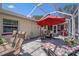 Spacious patio with ample seating, an outdoor grill, and a lounge chair for relaxation at 5583 Miles Dr, Port Orange, FL 32127