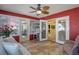 Well-lit sunroom with access to the backyard through sliding glass doors and neutral tile flooring at 5583 Miles Dr, Port Orange, FL 32127