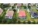Aerial view showcases the home's backyard pool with a screen enclosure, situated between well-maintained lawns at 5615 Oxford Moor Blvd, Windermere, FL 34786