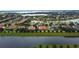 Aerial view of a lakeside neighborhood with well-maintained lawns and landscaping at 5615 Oxford Moor Blvd, Windermere, FL 34786