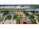 Aerial view of a home with red tile roof and beautiful landscaping near a lake at 5615 Oxford Moor Blvd, Windermere, FL 34786