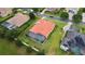 Aerial view of a suburban neighborhood with a red-roofed home, and a pool at 5615 Oxford Moor Blvd, Windermere, FL 34786