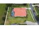 Aerial view of a beautiful single-Gathering home featuring a red tile roof, screened-in pool, and manicured landscaping at 5615 Oxford Moor Blvd, Windermere, FL 34786