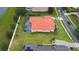 Aerial view of a home with red tile roof, a screened pool, and a large backyard at 5615 Oxford Moor Blvd, Windermere, FL 34786